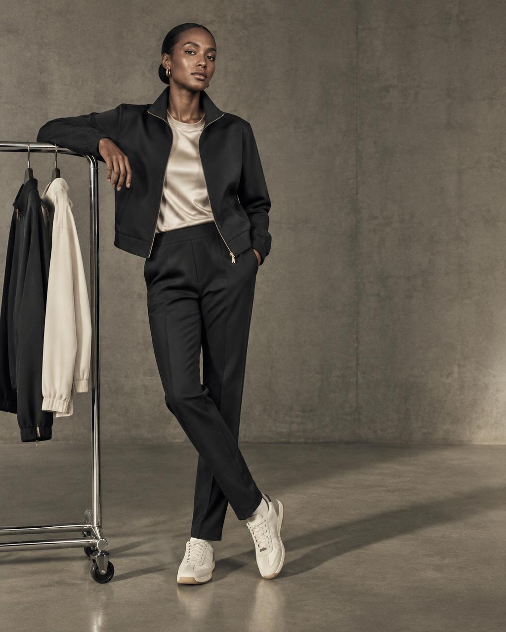 Black sportswear styled with champagne silk and cream sneakers